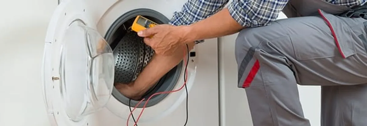 Dryer repair technician inspecting and repairing a clothes dryer in Richmond, VA