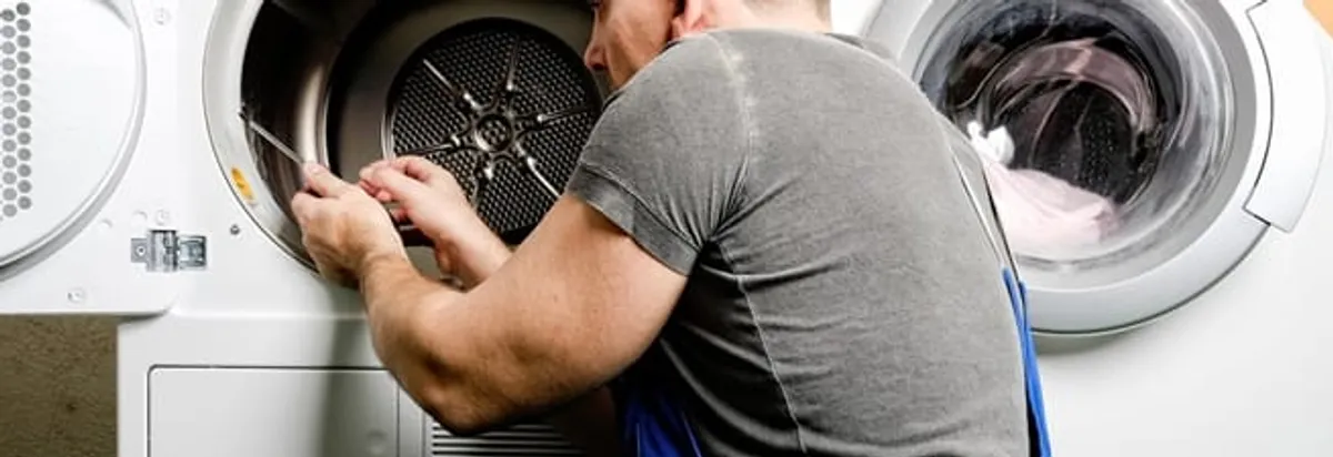 Dryer repair technician fixing a clothes dryer drum in Richmond, VA