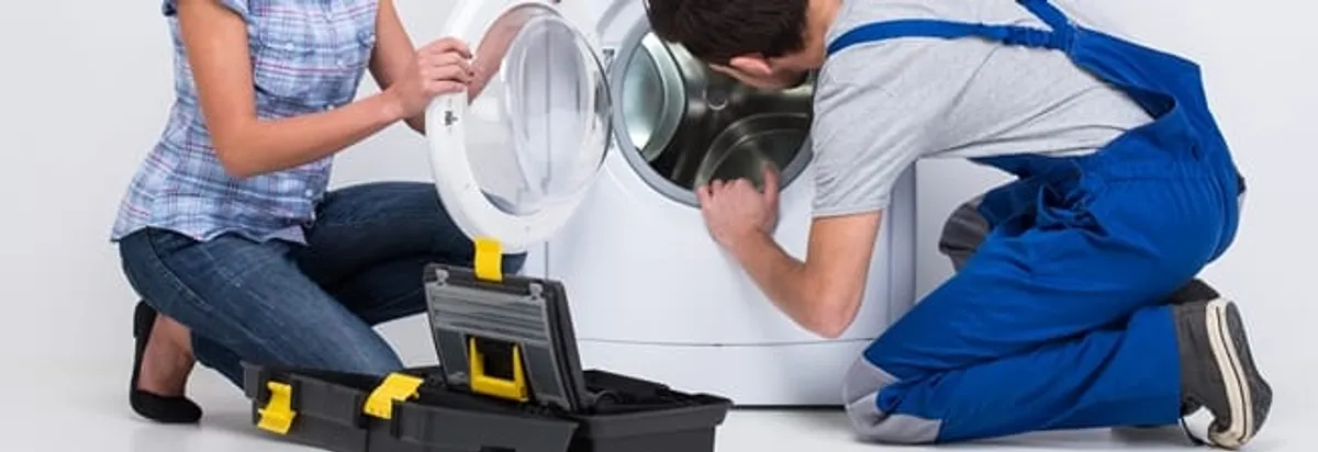 Washer repair technician inspecting a front-load washing machine with tools in Richmond, VA